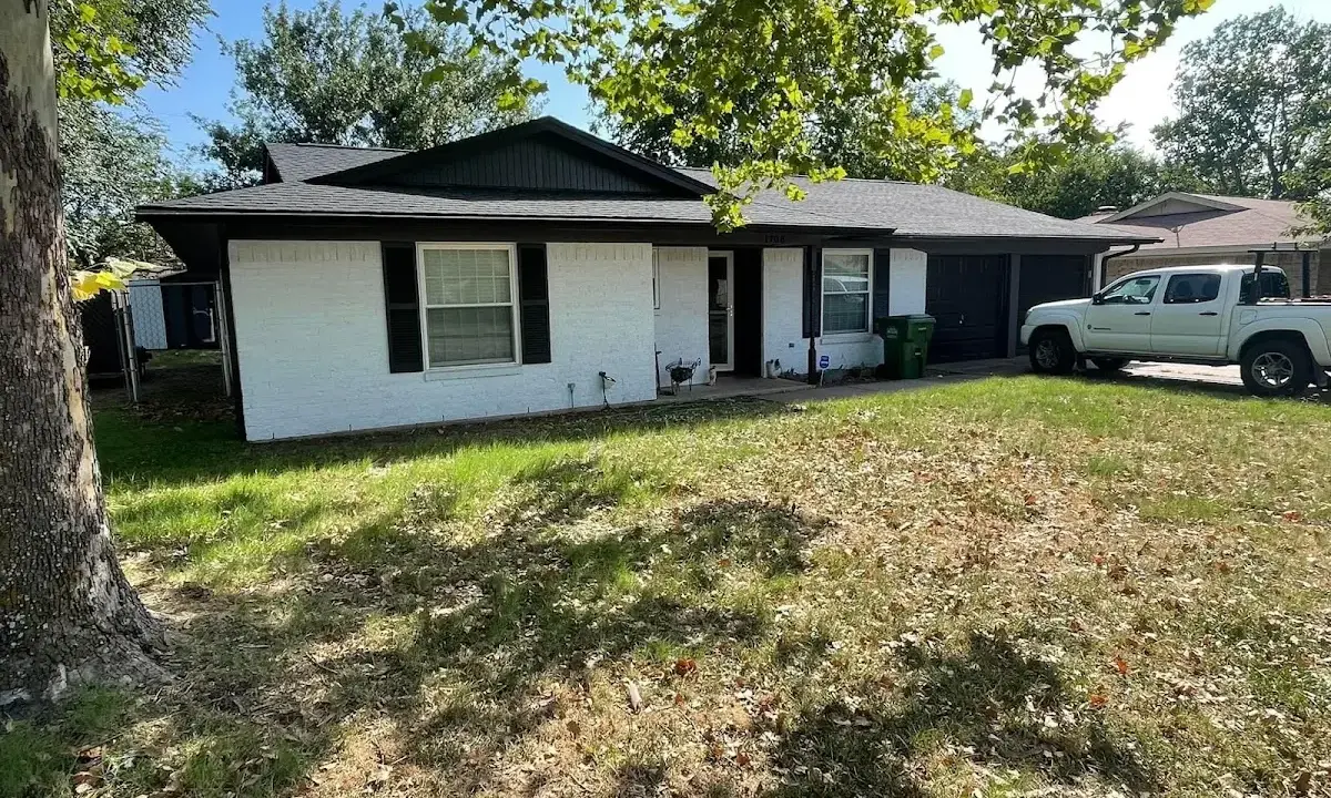 Professional roofing crew working on a residential roof in Starkville
